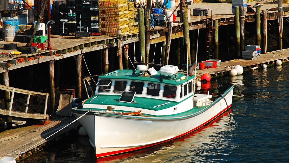 Commercial lobster boat A commercial lobster boat is docked on the coast of Portsmouth, New Hampshire. Image by Getty Images