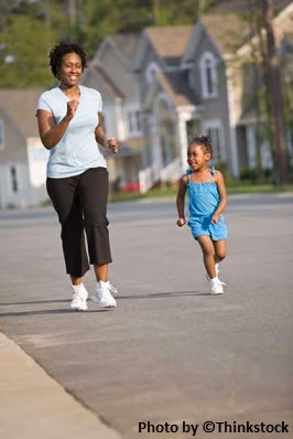 M6B1 A mother and daughter smiling, jogging in a neighborhood