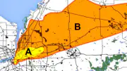 An arial view of a city map with colored shapes indicating areas of radiation exposure due to fallout.