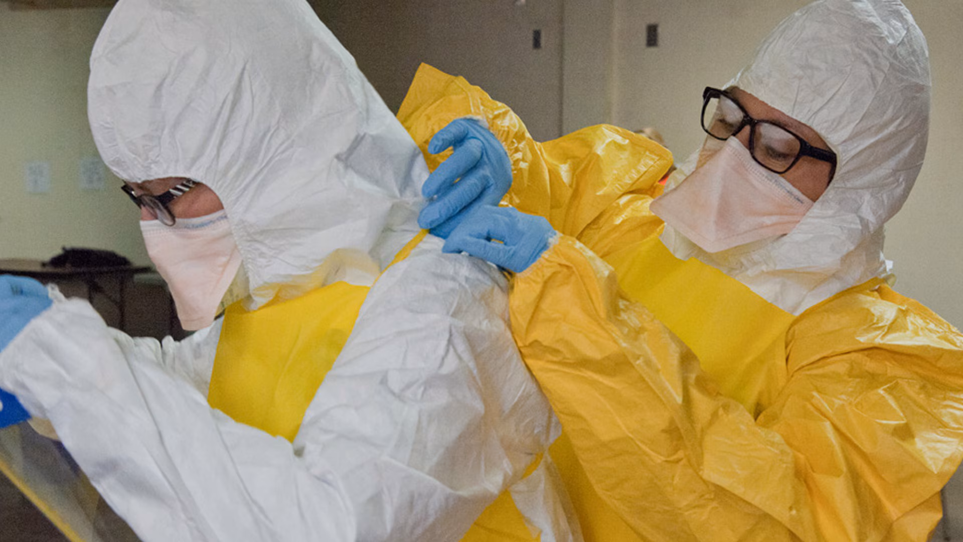 Healthcare workers putting on PPE.