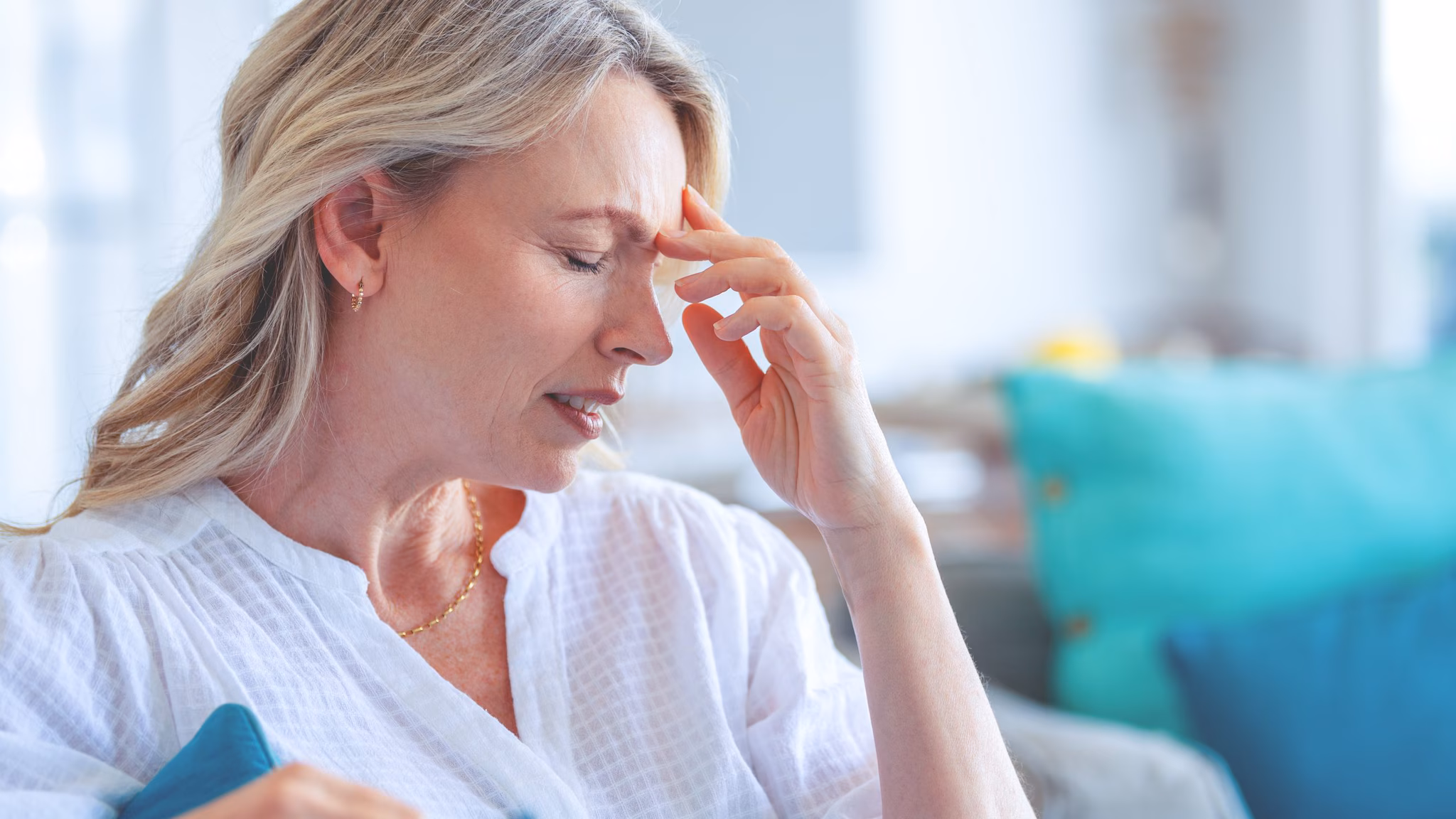 Woman not feeling well holding her head.