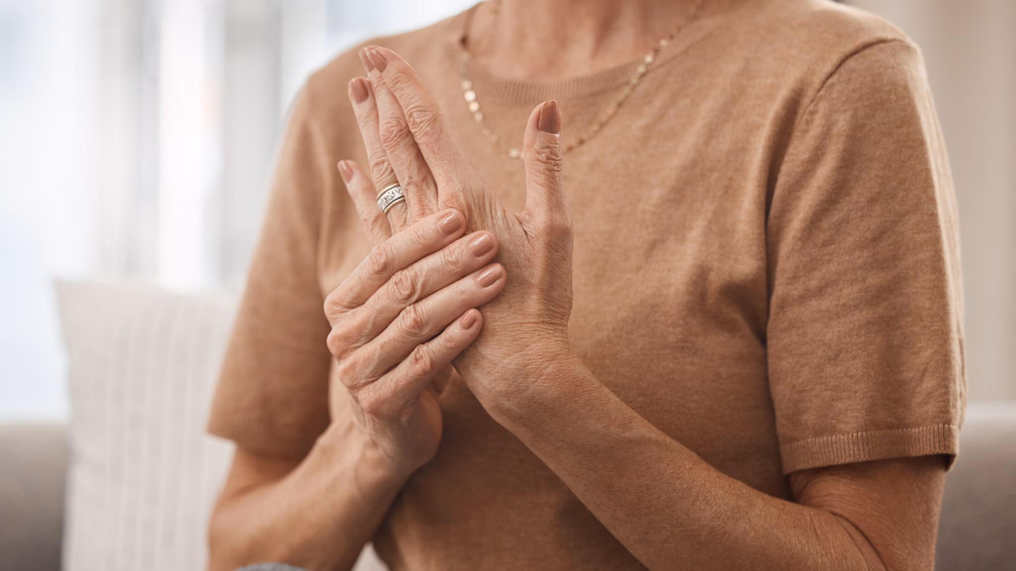 Woman Experiencing Pain in her hand Woman Experiencing Pain in her hand