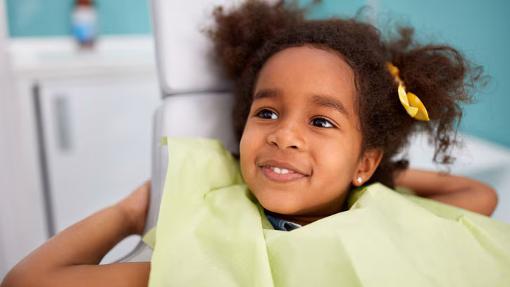 Smiling girl in dentist chair A young girl smiling in dentist chair.