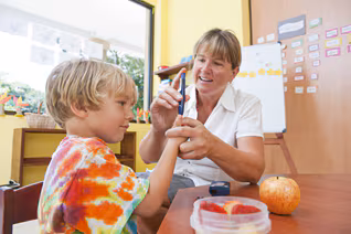 Diabetes_Tab2_3.png A school nurse administering a diabetes blood check for a student.