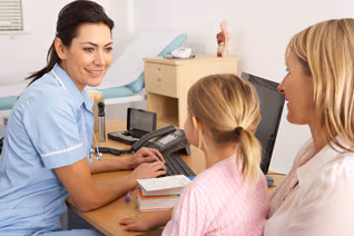A nurse is meeting with a female adult and child A nurse is meeting with a female adult and child.