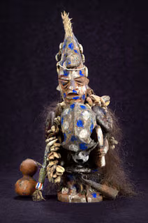 Shapona A statue with blue and gold colors, representing the West African god of smallpox.