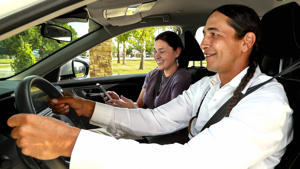 Couple driving Native American couple in car
