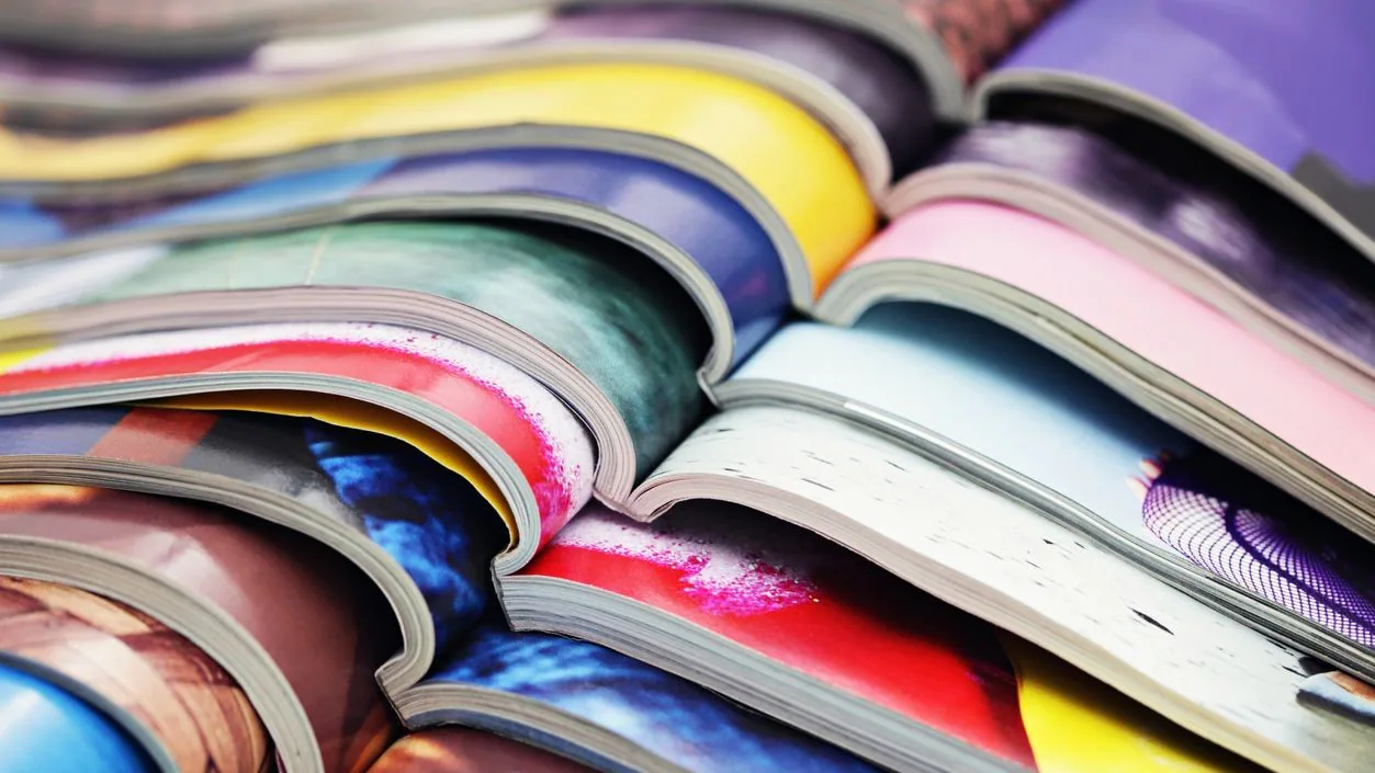 Publications A stack of open journals.