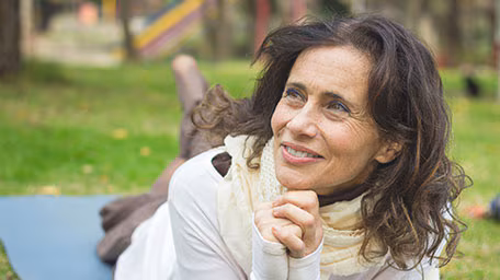 Woman outside lying on the ground