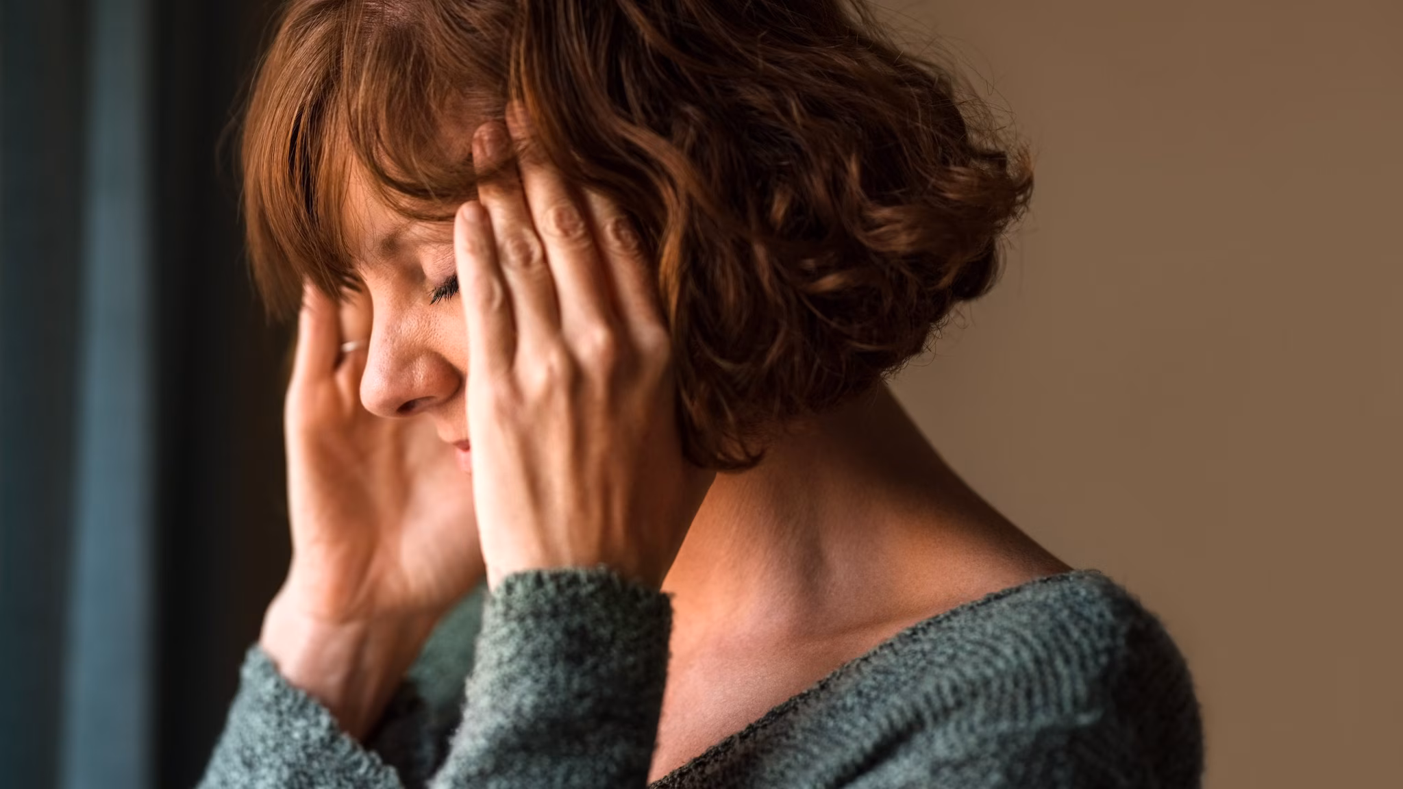 Woman holding her head in pain