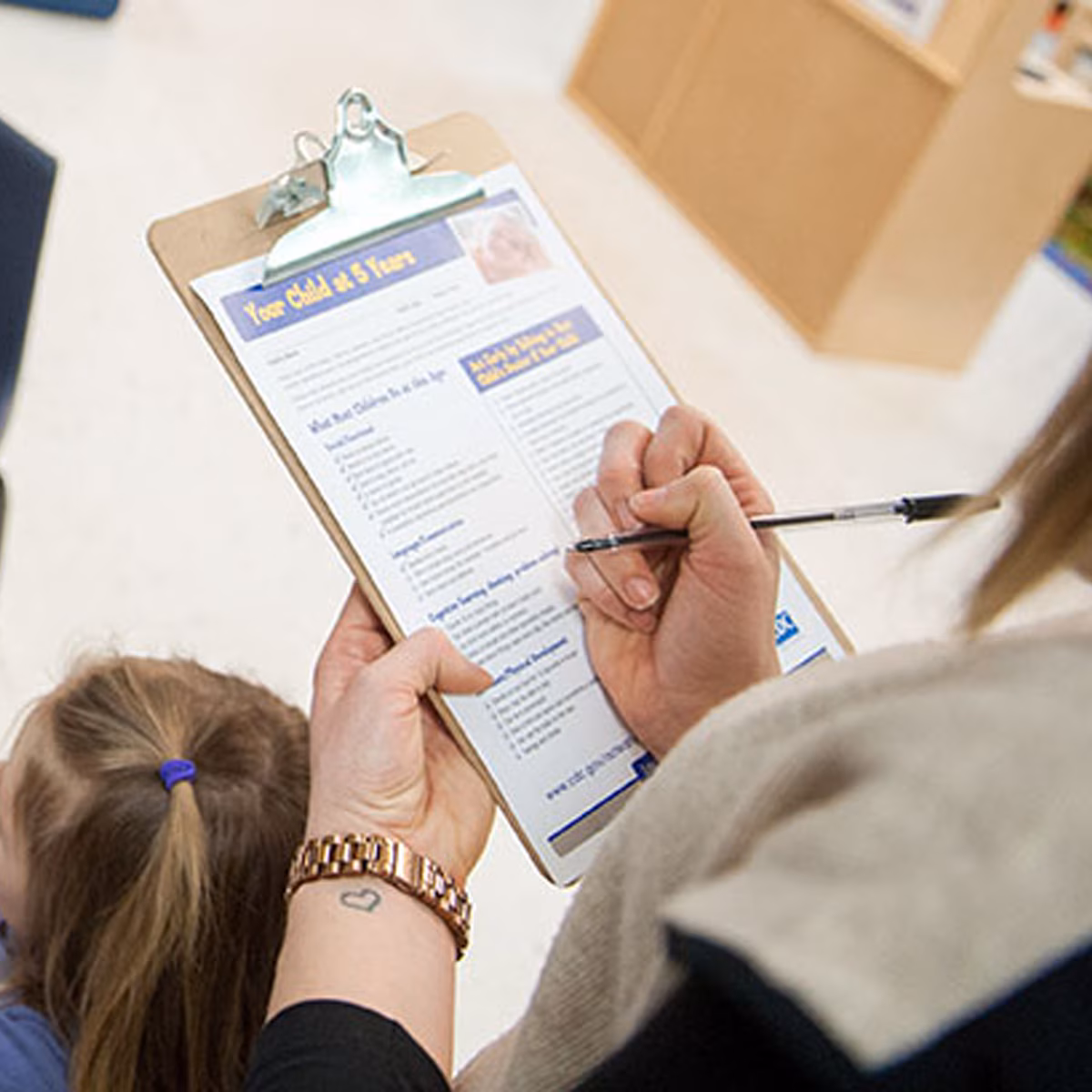 Your child at 5 yerars paperwork being filled out Your child at 5 yerars paperwork being filled out.
