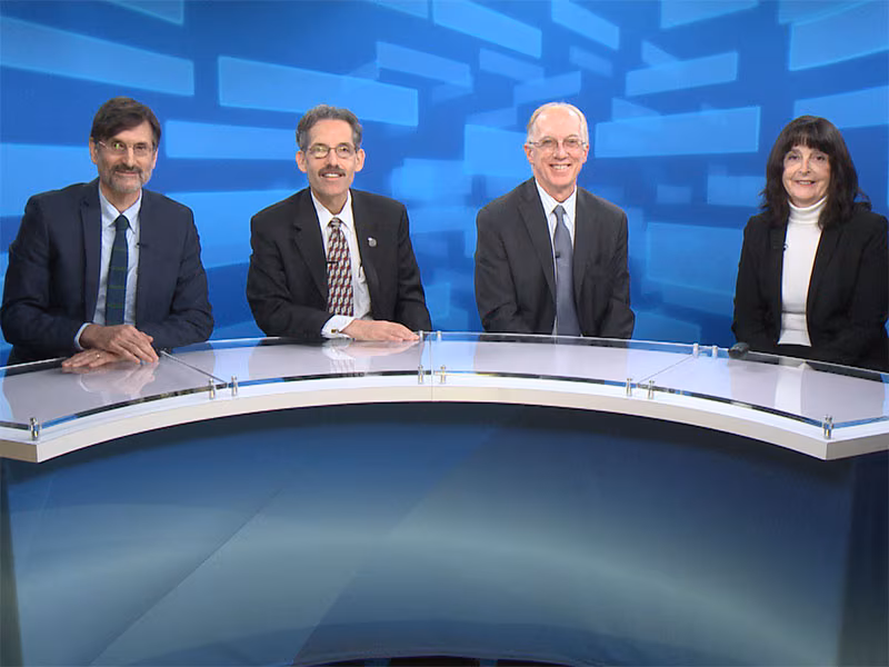 Dr. Farfel, Dr. Prezant, Dr. Crane, and Dr. Ward sitting around a semi-circular desk preparing to discuss Cancer and the World Trade Center Health Program