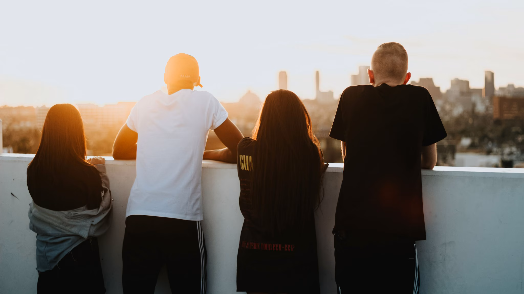 Substance use Youth standing on the deck of a tall building looking out into a city.
